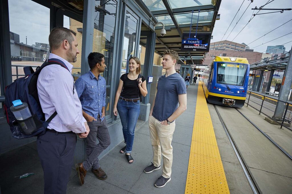 people talking while train approaches