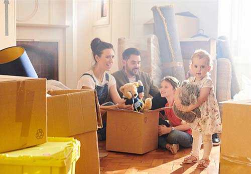 Family taking stuffed bear out of box